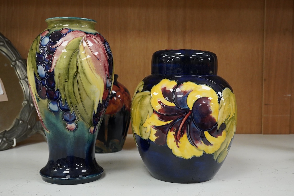 Three Moorcroft vases and a Moorcroft Hibiscus jar and cover, largest 25cm high